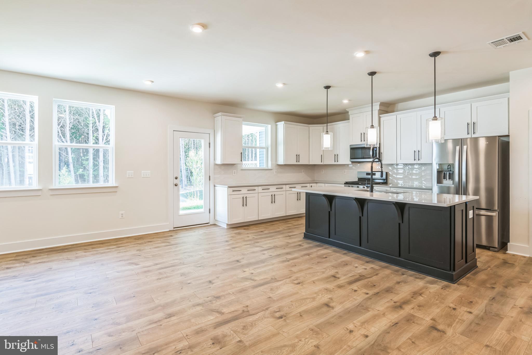 383 Scranton Lane Ocean View, DE 19970 - Photo 5 of 15 a large kitchen with a large window and stainless steel appliances