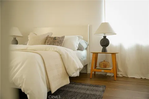 a bed sitting in a bedroom next to a lamp