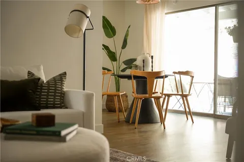 a living room with furniture and a floor to ceiling window