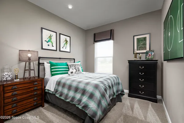 a bedroom with a bed and a dresser