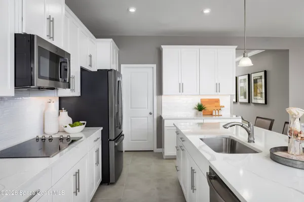 a kitchen with a sink stove and refrigerator