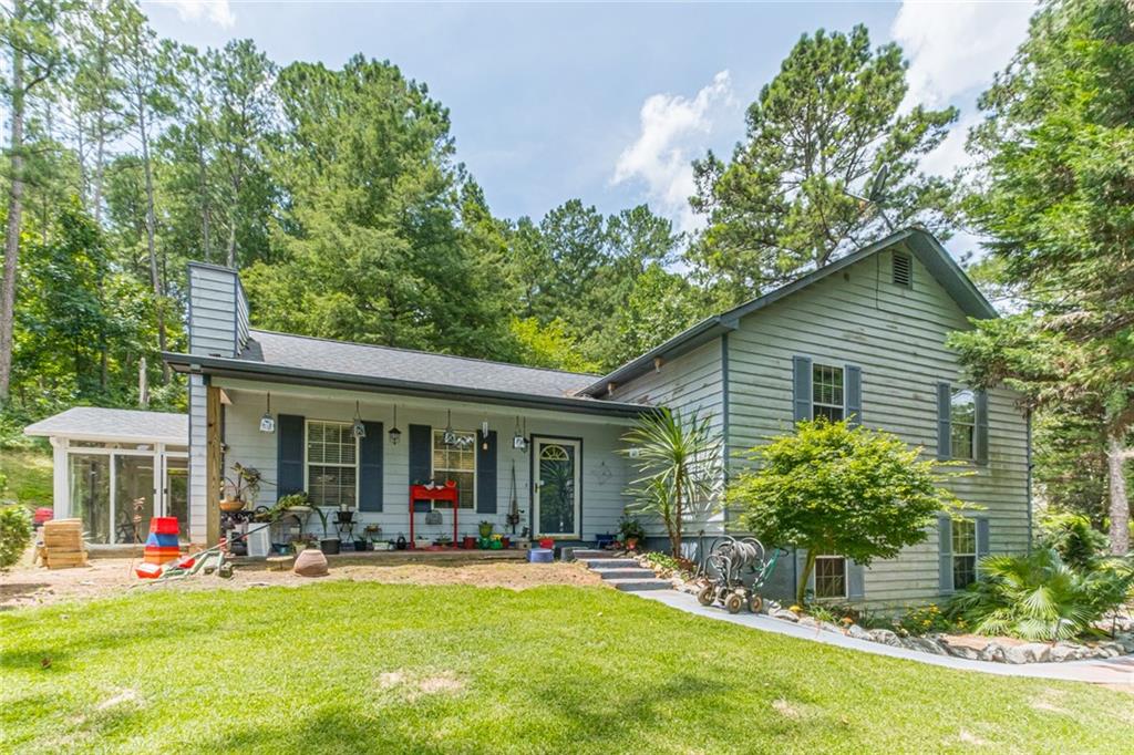 4160 Bullock Bridge Road Loganville, GA 30052 - Photo 1 of 1 a view of a house with sitting area and garden