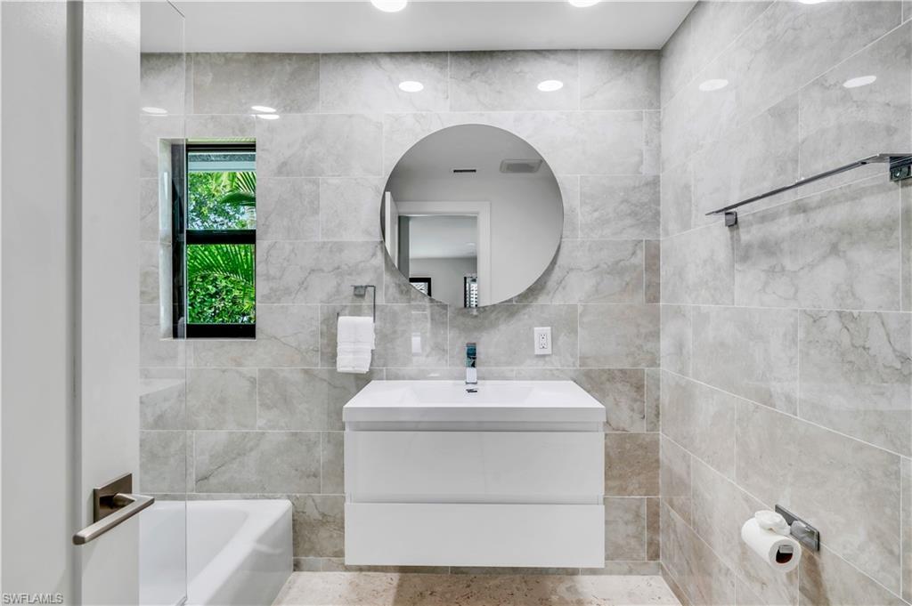 3777 Fountainhead Lane Naples, FL 34103 - Photo 12 of 18 a bathroom with a sink a toilet and shower
