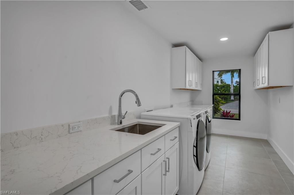 3777 Fountainhead Lane Naples, FL 34103 - Photo 15 of 18 a kitchen with a sink a stove and cabinets