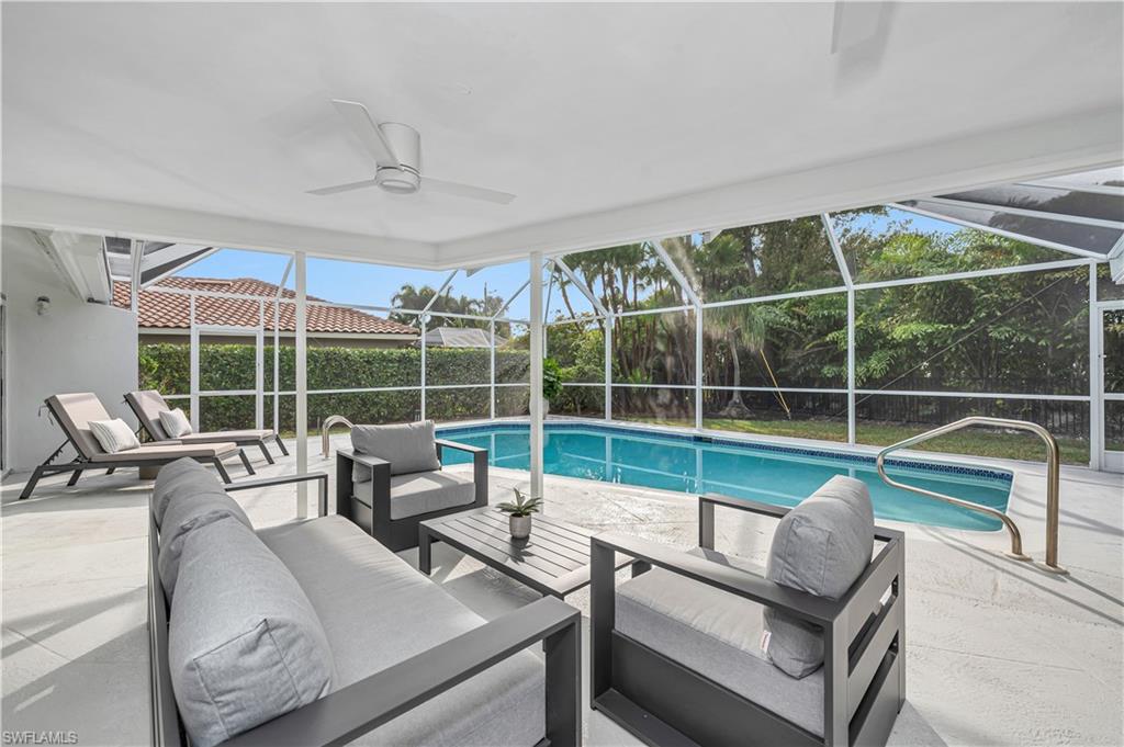 3777 Fountainhead Lane Naples, FL 34103 - Photo 16 of 18 a living room with furniture and a large window