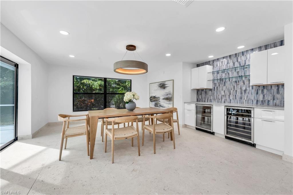 3777 Fountainhead Lane Naples, FL 34103 - Photo 5 of 18 a dining room with a table and chairs