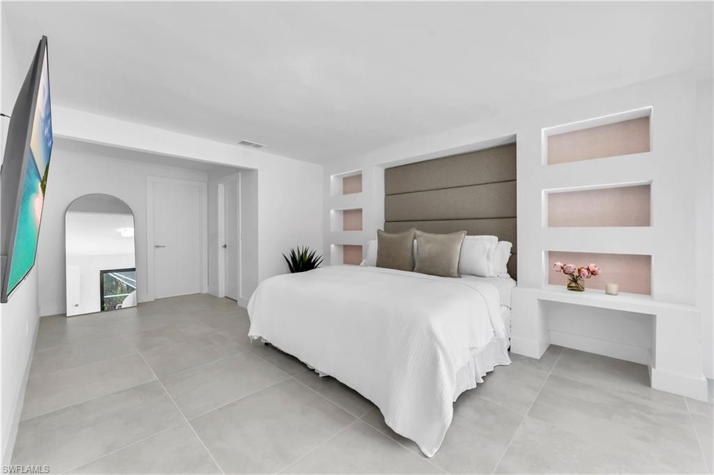 3777 Fountainhead Lane Naples, FL 34103 - Photo 6 of 18 a bedroom with a bed and a window
