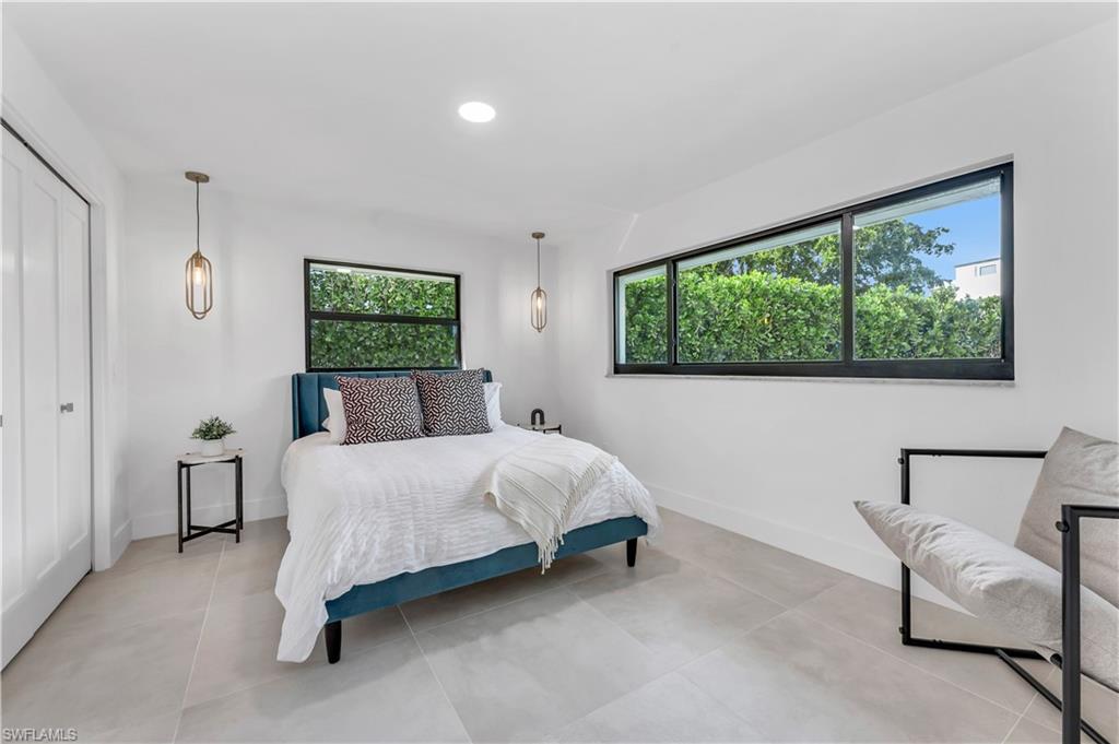 3777 Fountainhead Lane Naples, FL 34103 - Photo 10 of 18 a bed room with a bed and a chair