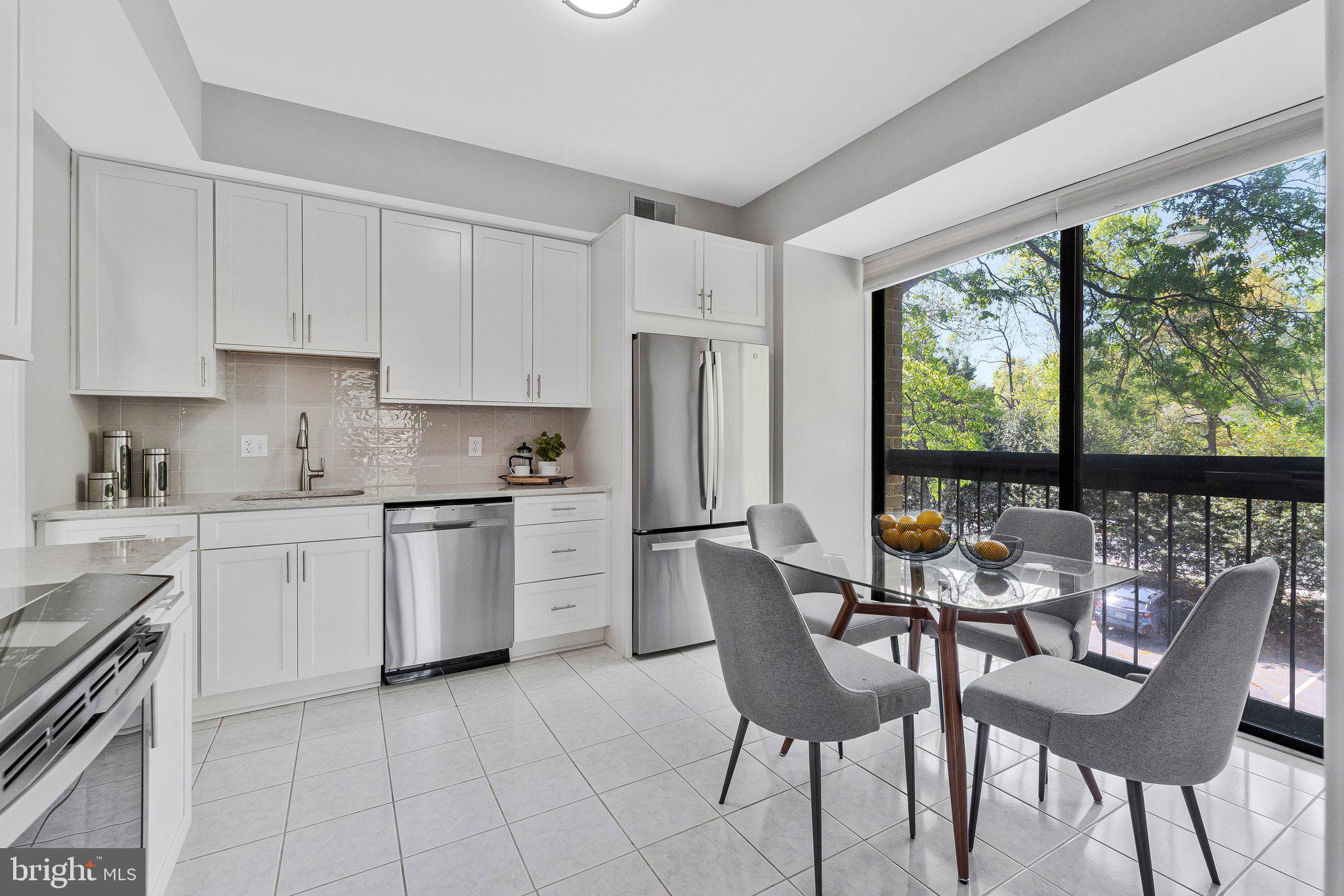 11616 Ivystone Court, Unit 5/300A Reston, VA 20191 - Photo 12 of 25 a kitchen with a dining table chairs and refrigerator