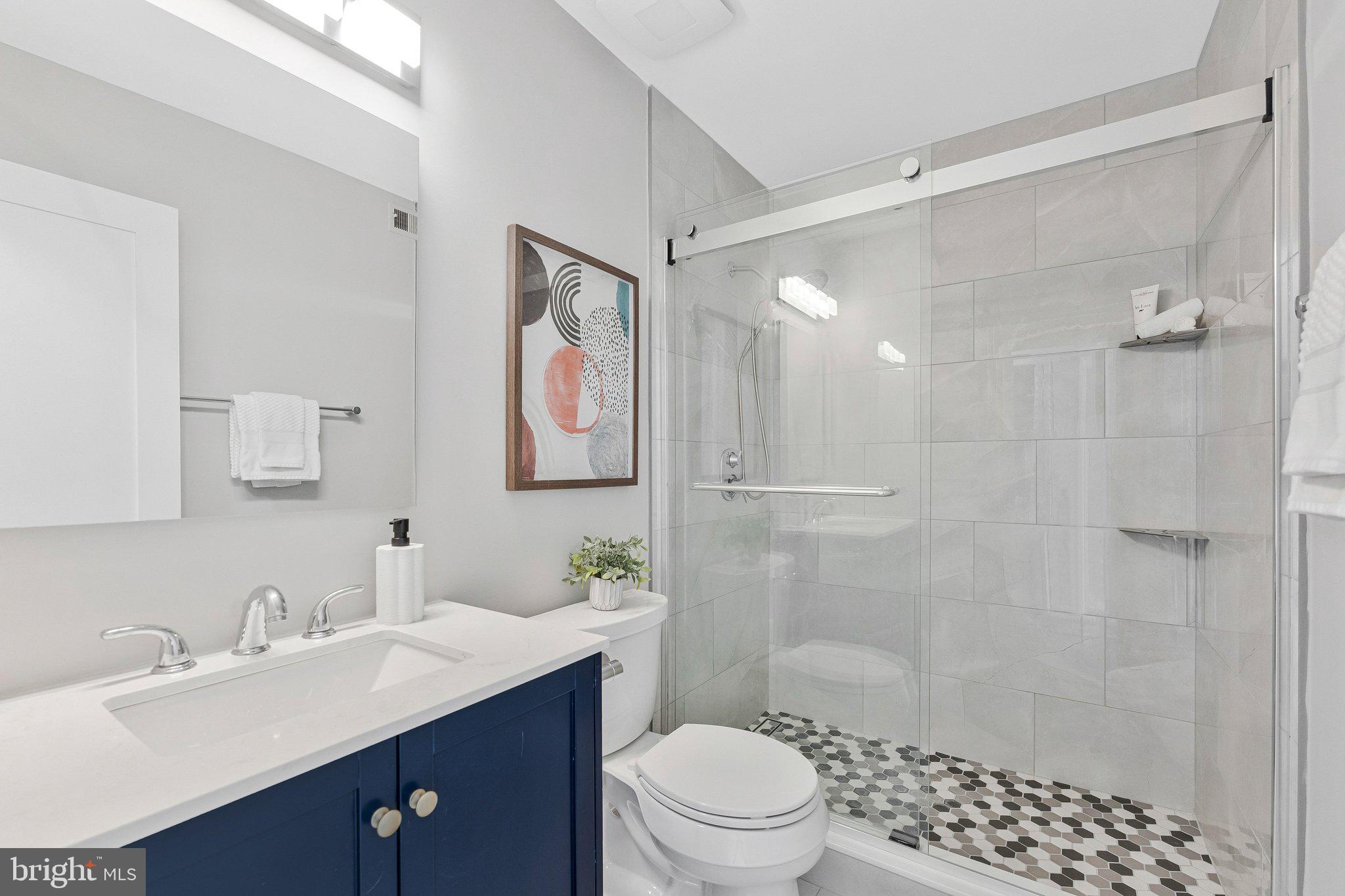 11616 Ivystone Court, Unit 5/300A Reston, VA 20191 - Photo 16 of 25 a bathroom with a sink toilet a mirror and shower