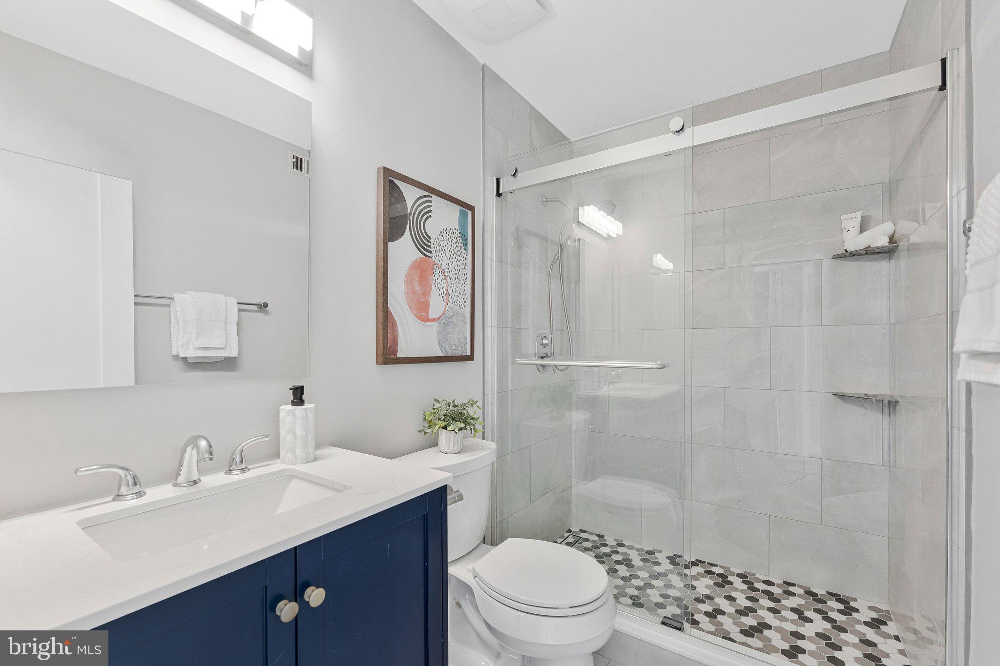 11616 Ivystone Court, Unit 5/300A Reston, VA 20191 - Photo 23 of 25 a bathroom with a sink toilet a mirror and shower