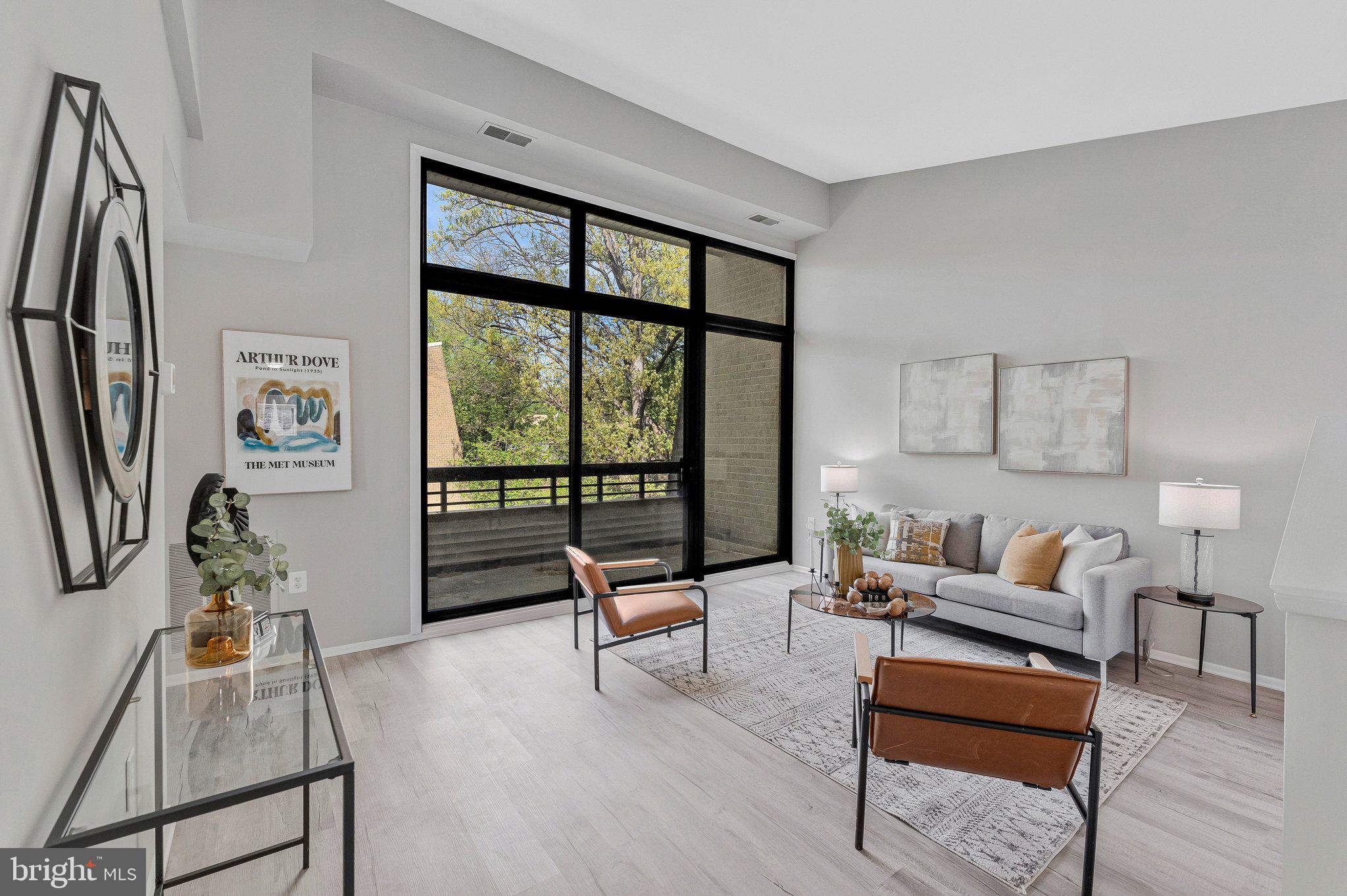 11616 Ivystone Court, Unit 5/300A Reston, VA 20191 - Photo 4 of 25 a living room with furniture and a large window