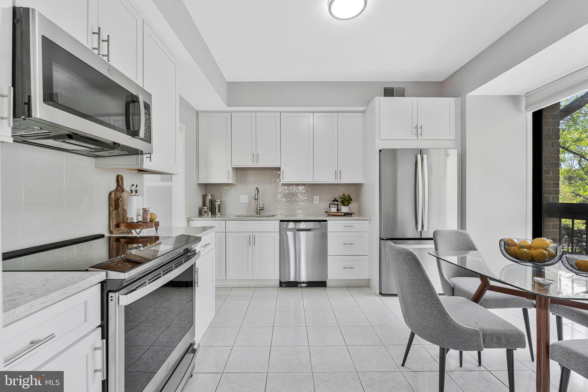 11616 Ivystone Court, Unit 5/300A Reston, VA 20191 - Photo 10 of 25 a kitchen with a stove a sink and a refrigerator