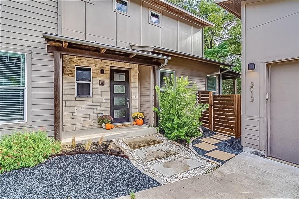 a view of a house with potted plants