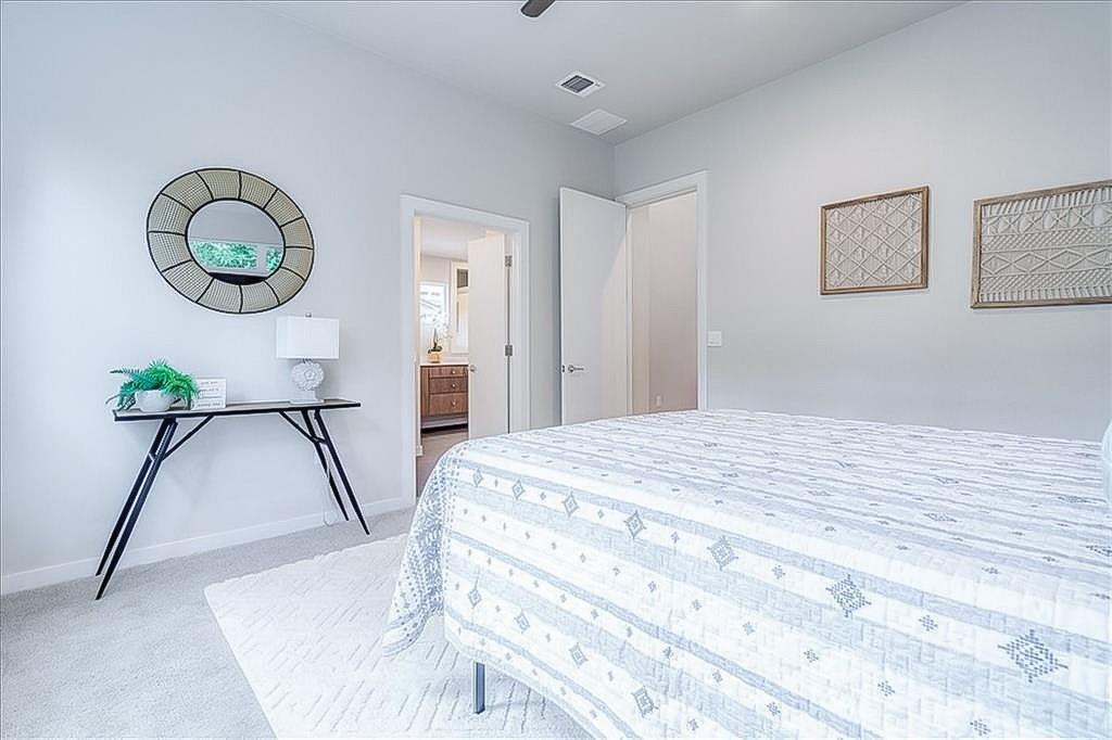 3913 Valley View Road, Unit B Austin, TX 78704 - Photo 14 of 24 a bedroom with a bed and a chandelier