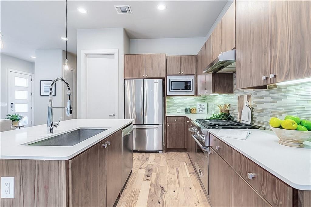3913 Valley View Road, Unit B Austin, TX 78704 - Photo 7 of 24 a kitchen with a sink stove and refrigerator