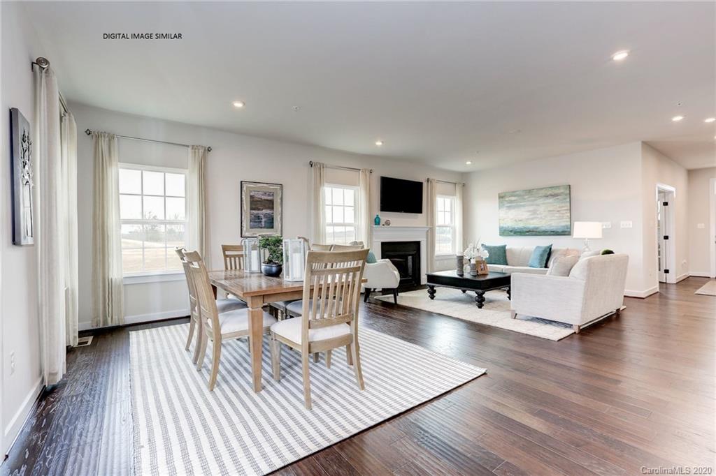 7105 Messina Road, Unit 127 Indian Land, SC 29707 - Photo 5 of 13 a living room with fireplace furniture and a wooden floor