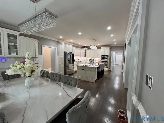 a kitchen with stainless steel appliances granite countertop a refrigerator sink and cabinets