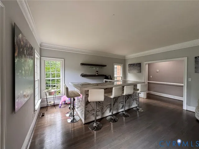 a dining room with furniture and wooden floor