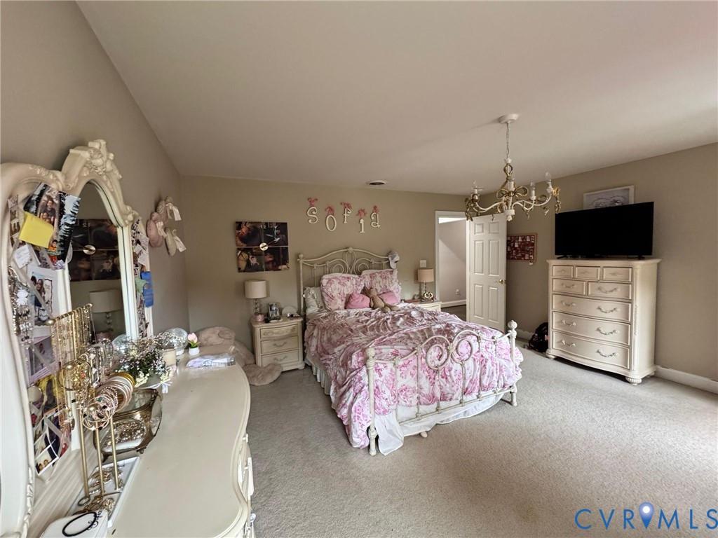 3231 Queens Grant Drive Midlothian, VA 23113 - Photo 29 of 48 a spacious bedroom with bed and a flat tv screen