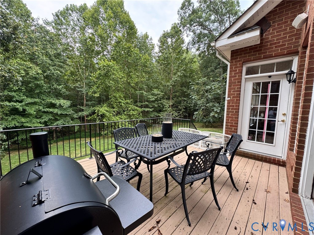 3231 Queens Grant Drive Midlothian, VA 23113 - Photo 44 of 48 a view of a roof deck with table and chairs couches with wooden floor and lake view