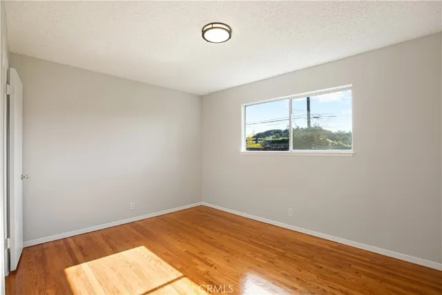 a living room with patio furniture and a garden