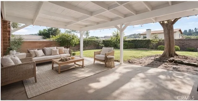 a view of a backyard with floor to ceiling window and tree
