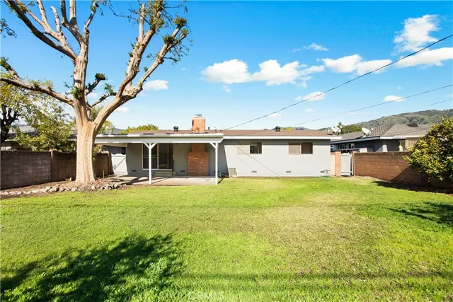 an aerial view of a residential houses with yard