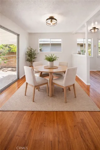 a dining room with furniture and wooden floor