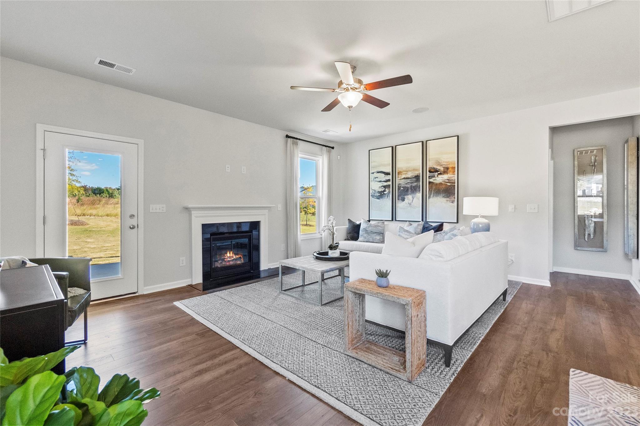 3107 Laurel Brook Drive Denver, NC 28037 - Photo 11 of 31 a living room with furniture a fireplace and a chandelier