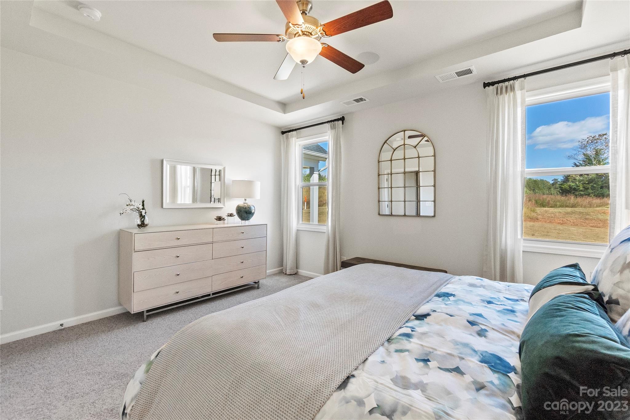 3107 Laurel Brook Drive Denver, NC 28037 - Photo 15 of 31 a bedroom with a bed next to a window and a chandelier