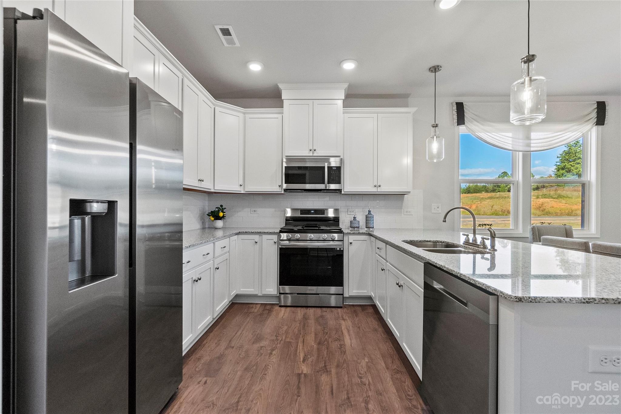 3107 Laurel Brook Drive Denver, NC 28037 - Photo 7 of 31 a kitchen with stainless steel appliances granite countertop a stove a refrigerator and a sink
