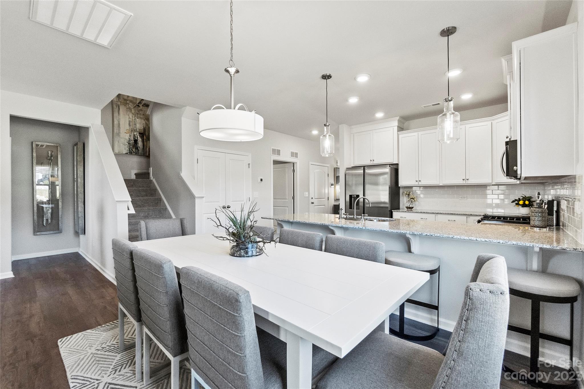 3107 Laurel Brook Drive Denver, NC 28037 - Photo 9 of 31 a kitchen with stainless steel appliances kitchen island granite countertop a dining table chairs sink and cabinets