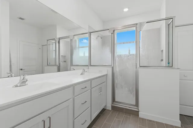 a bathroom with a double vanity sink and mirror