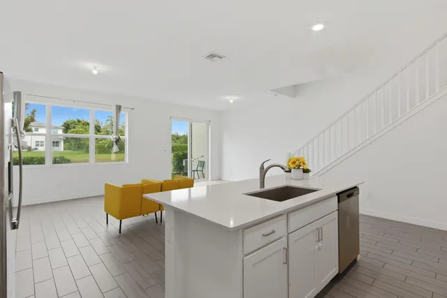 a kitchen with a sink cabinets and window
