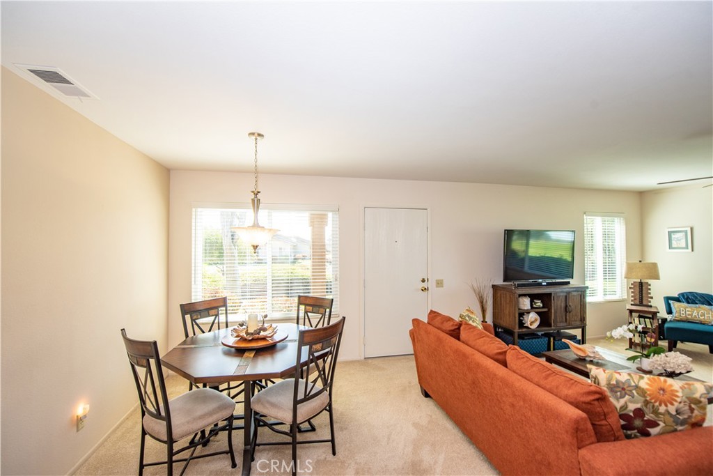 4433 Albatross Way Oceanside, CA 92057 - Photo 16 of 47 a living room with furniture a fireplace and a flat screen tv