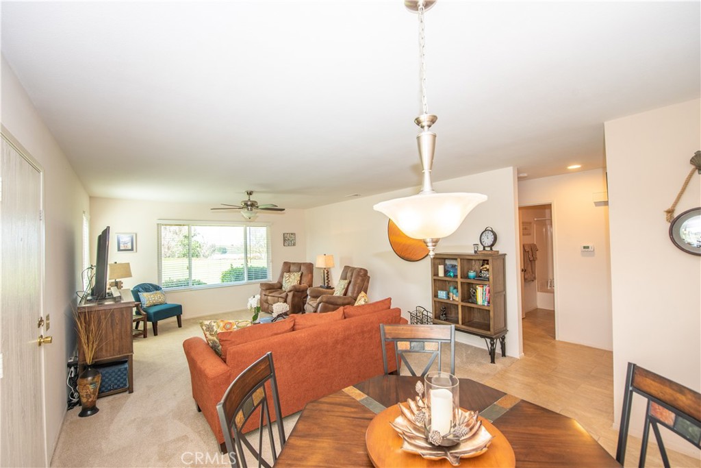 4433 Albatross Way Oceanside, CA 92057 - Photo 17 of 47 a living room with furniture a dining table and a chandelier
