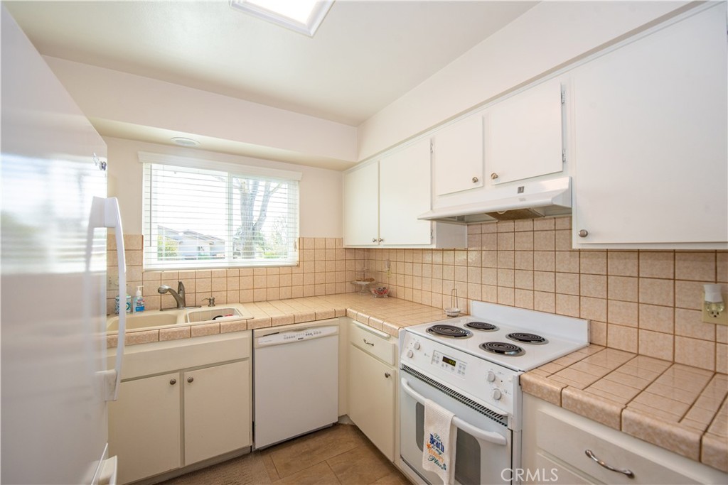 4433 Albatross Way Oceanside, CA 92057 - Photo 22 of 47 a view of a kitchen with a sink stove and cabinets