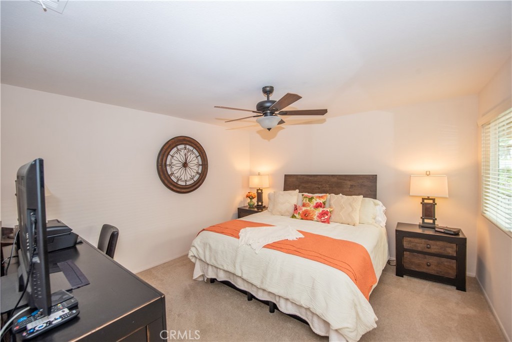 4433 Albatross Way Oceanside, CA 92057 - Photo 27 of 47 a bedroom with a bed and a chandelier