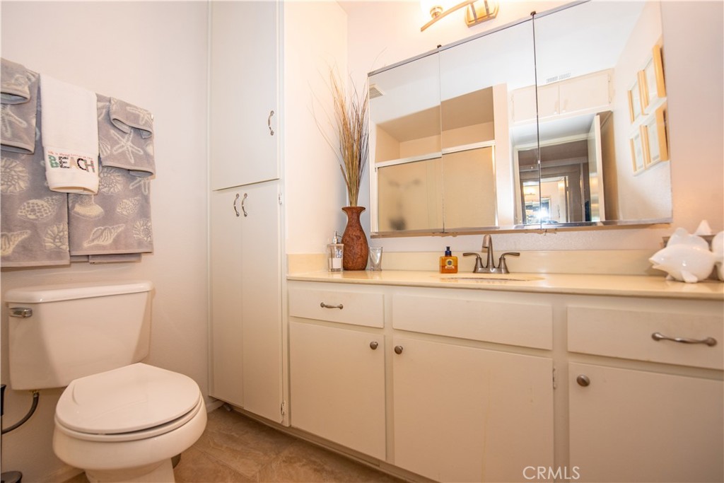 4433 Albatross Way Oceanside, CA 92057 - Photo 29 of 47 a bathroom with a toilet a sink and mirror