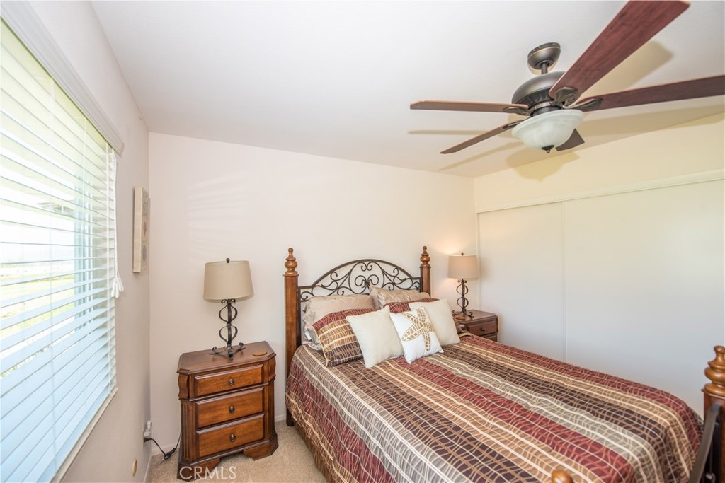 4433 Albatross Way Oceanside, CA 92057 - Photo 30 of 47 a bedroom with a bed and ceiling fan
