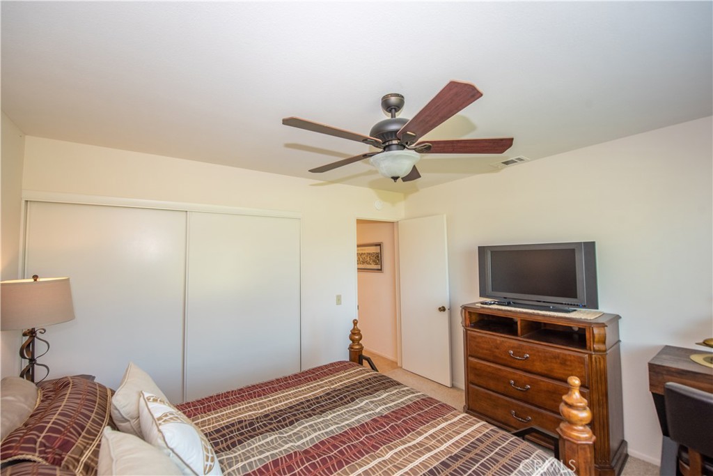 4433 Albatross Way Oceanside, CA 92057 - Photo 31 of 47 a bedroom with a bed and a flat screen tv