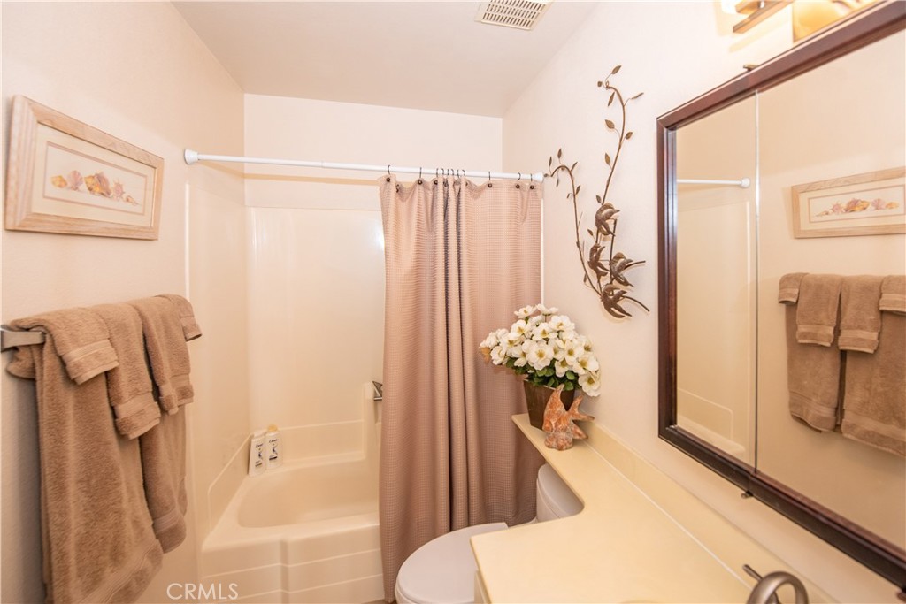 4433 Albatross Way Oceanside, CA 92057 - Photo 33 of 47 a bathroom with a shower curtain and a sink