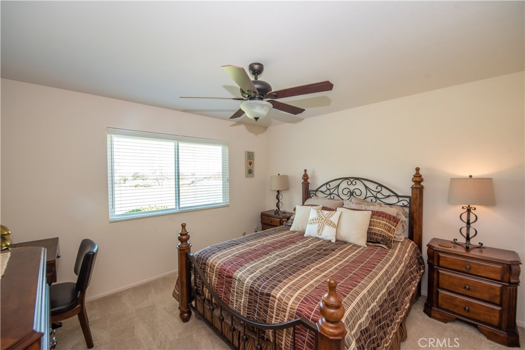 4433 Albatross Way Oceanside, CA 92057 - Photo 35 of 47 a bedroom with a bed and a chandelier