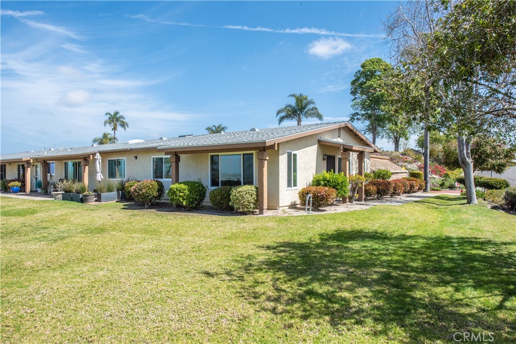 4433 Albatross Way Oceanside, CA 92057 - Photo 4 of 47 a front view of a house with a yard and trees