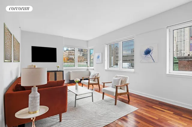 a living room with furniture a flat screen tv and a window