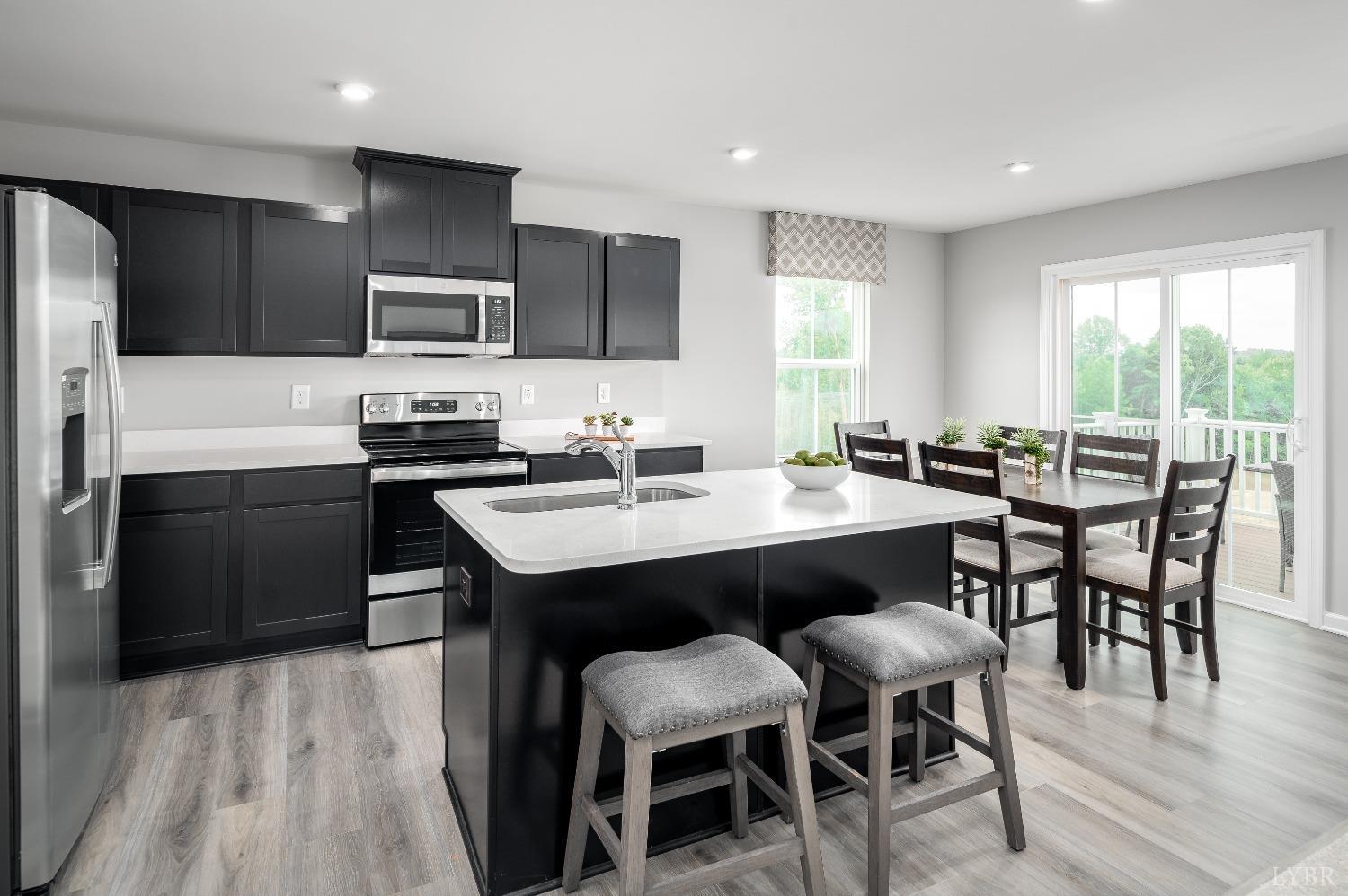 130 Robinia Road Lynchburg, VA 24501 - Photo 2 of 14 a kitchen with a dining table chairs and refrigerator