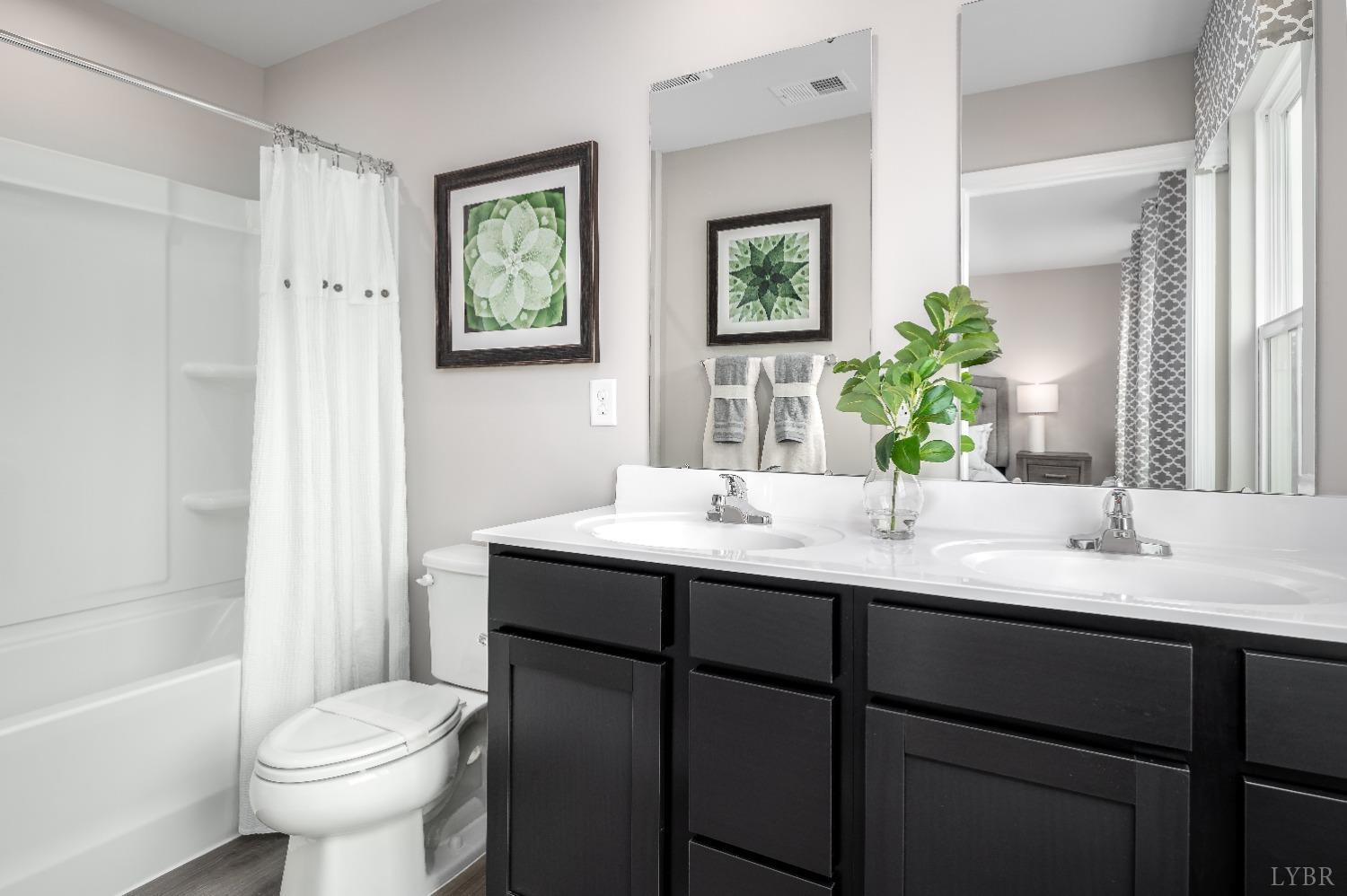 130 Robinia Road Lynchburg, VA 24501 - Photo 9 of 14 a bathroom with a toilet sink and mirror