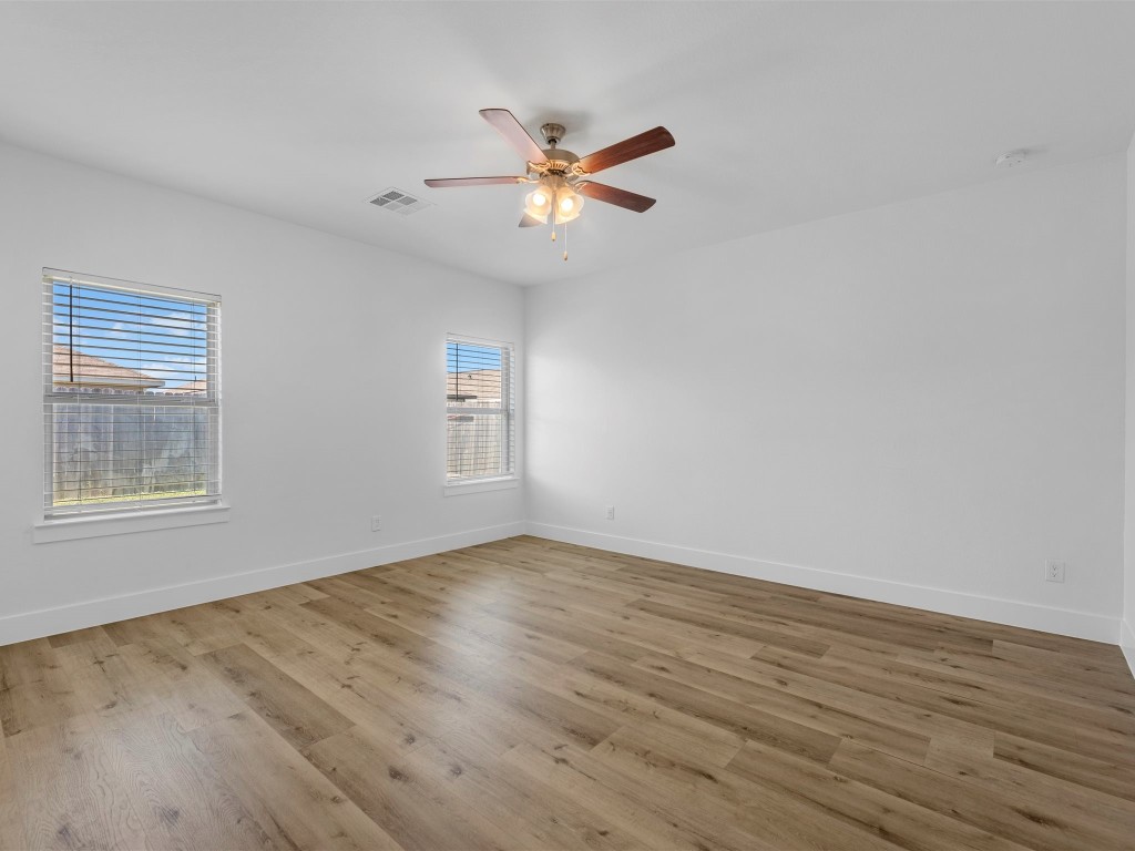 24751 Russet Bluff Trail Houston, TX 77336 - Photo 15 of 26 a view of an empty room with wooden floor and a window