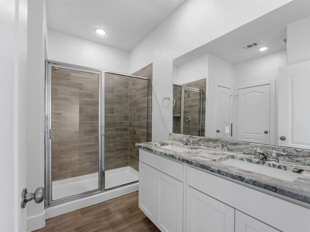 24751 Russet Bluff Trail Houston, TX 77336 - Photo 17 of 26 a bathroom with a granite countertop sink and shower